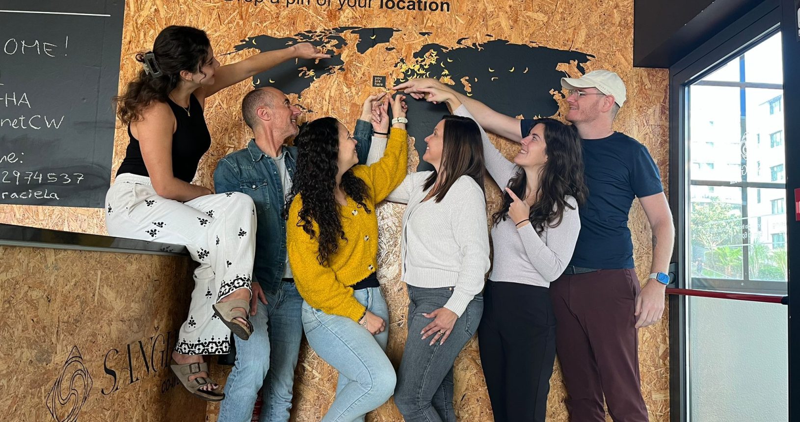 Sangha Cowork members pinning their home locations on the world map, Funchal