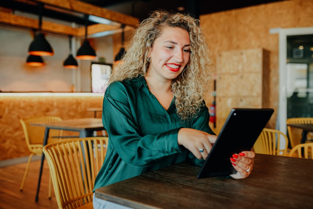 Professional working on a tablet in the bar area at Sangha Cowork, Funchal