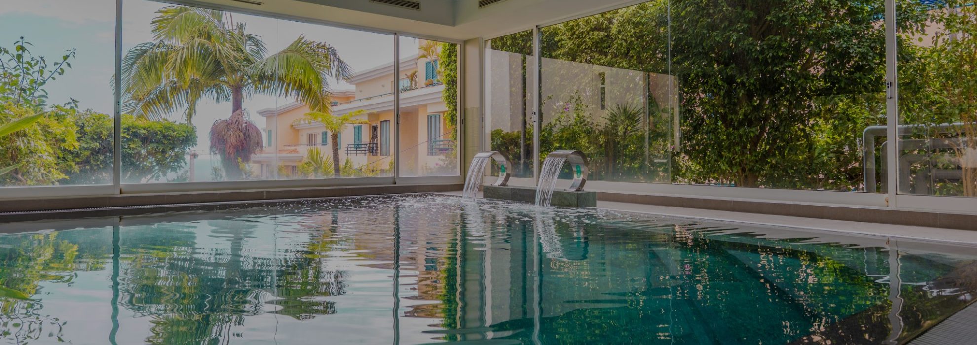 Indoor pool with tropical garden view at Dorisol Hotels, Funchal